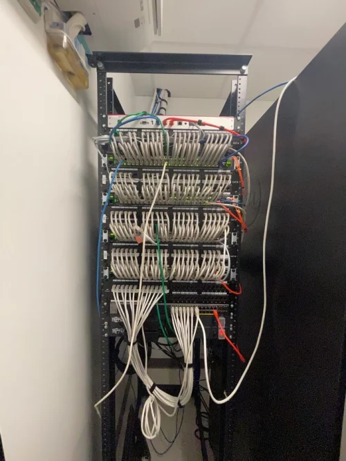 Multiple patch panel connected to multiple network switches.
